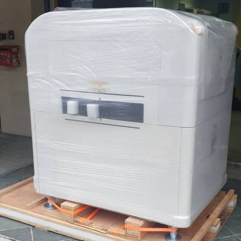 A machine shrink-wrapped with corner protection on a pallet ready for shipping